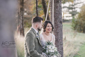 Bride and groom sitting on the Gailes Swing