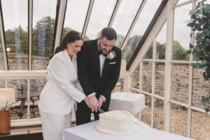 Bride and groom cutting cake