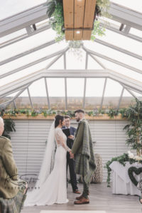 Bride and Groom standing at the Alter in the Gailes Hotel Ceremony room