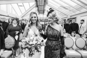 Mother walking bride down the aisle