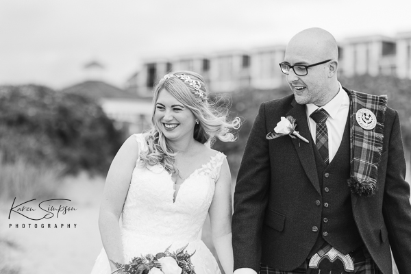 Waterside-Hotel-Aayrshire-Scotland (1 of 1) Bride and groom walking on the beach