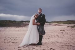 down the beach, bride and groom