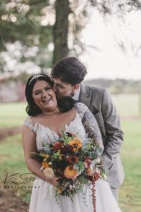 Groom kissing bride's cheek