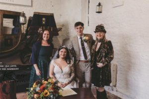 Brides family signing the register in the coach house