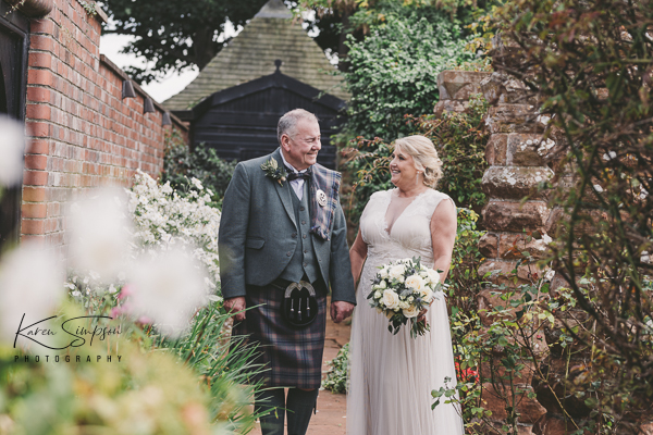 Bride in groom in Piersland House gardens in the summer