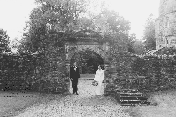Bride and groom at castle arch