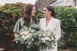 Bride and Bridesmaid in green dress and white suit
